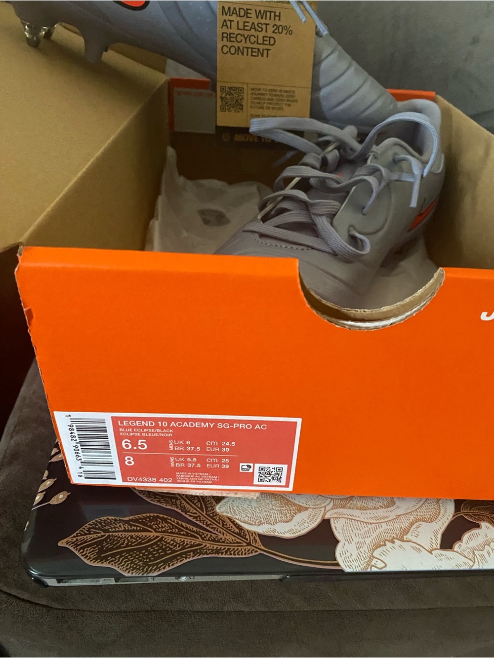 Nike Kids Gray Soccer Cleats with Orange Swoosh